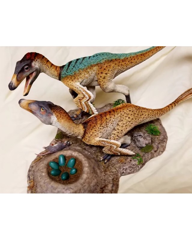 A sculpture of two feathered raptors above a nest of blue green eggs, a small mammal at their feet, by Shane Foulkes.