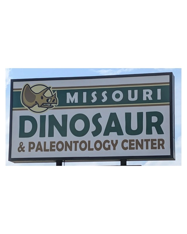 The Missouri Dinosaur and Paleontology Center sign against the sky.