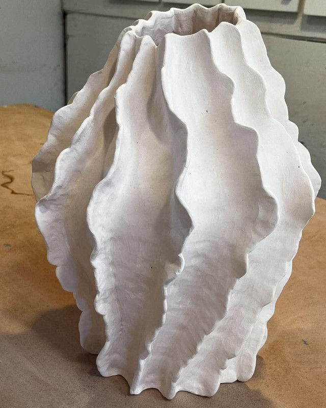 A white ceramic vessel with deep rippling folds, by Shoshana Parry.